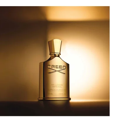 Gold Creed perfume bottle with text CREED MILLÉSIME IMPÉRIAL DE PÈRE EN FILS DEPUIS 1760 FROM FATHER TO SON SINCE 1760 100 ML 3.33 FL. OZ.