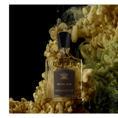 A bottle of Creed Royal Oud perfume surrounded by yellow and green swirls on a black background with the text CREED ROYAL OUD DE PÈRE EN FILS DEPUIS 1760 FROM FATHER TO SON SINCE 1760 100ML 3.33 FL. OZ.