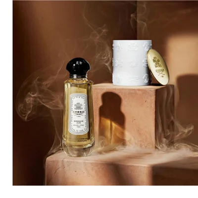 A pink rose is disintegrating with petals and particles flying outwards against a black background.