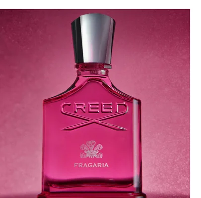 A pink Creed perfume bottle with a silver cap is shown on a pink background, with text CREED and FRAGARIA visible on the bottle.