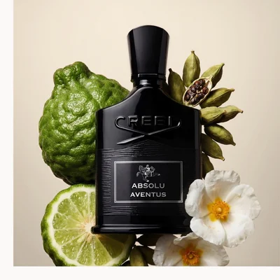Creed Absolu Aventus black bottle with citrus, spices, woods, and herbs displayed on a white background.
