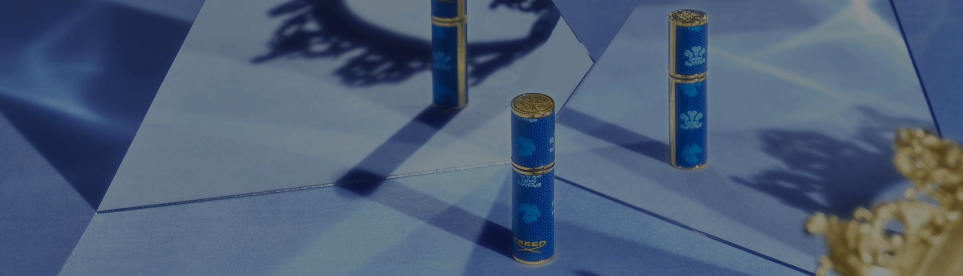 Creed Blue Leather Travel Atomiser next to crown
